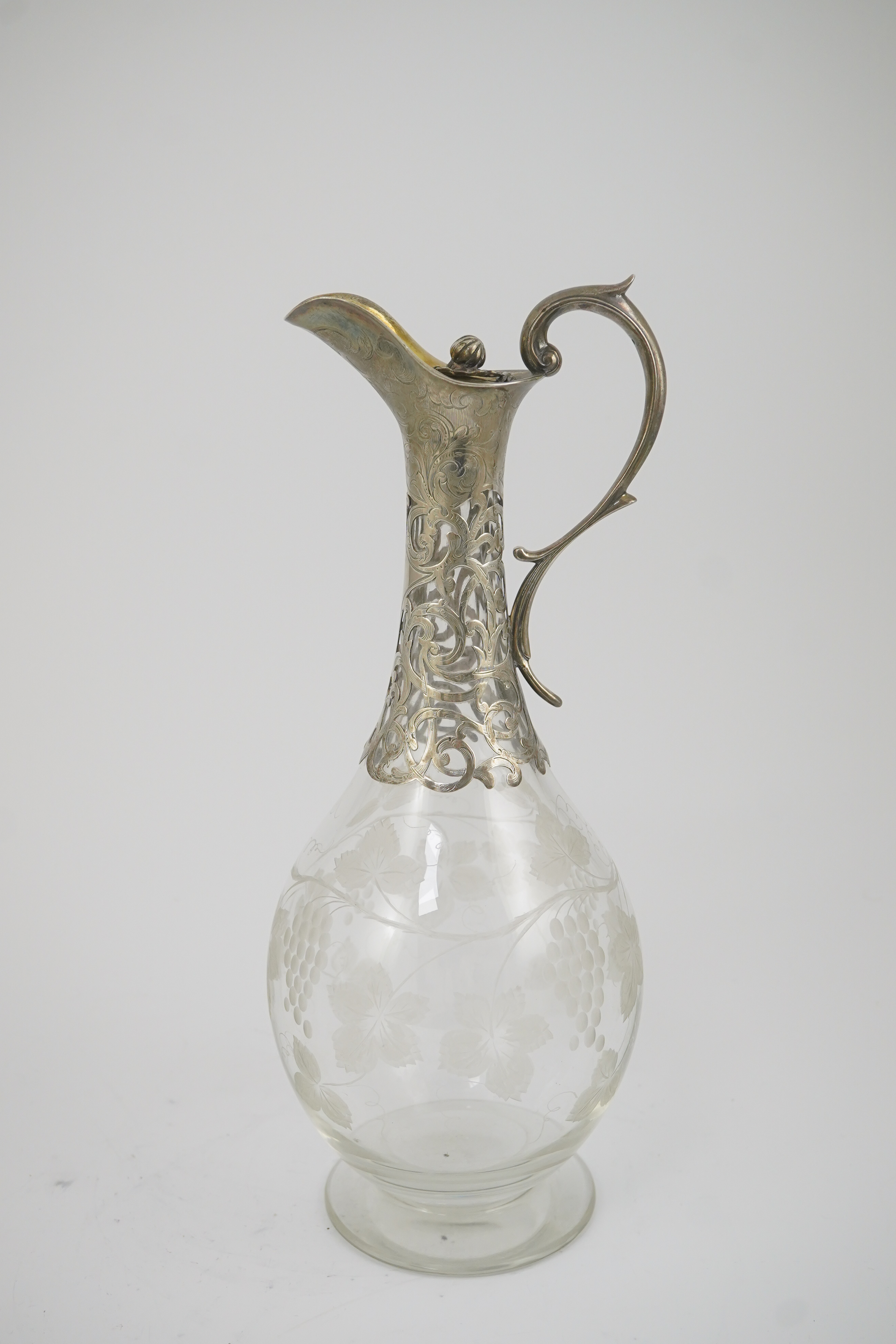 A Victorian parcel gilt silver mounted glass pyriform claret jug, by Joseph Angell II